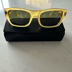 Men’s Persol Miele sunglasses with green crystal lenses in an acetate frame.